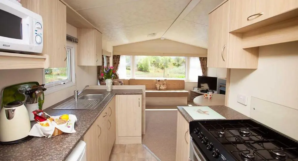 a small kitchen with a sink and a stove at The Hide near Aviemore in Aviemore