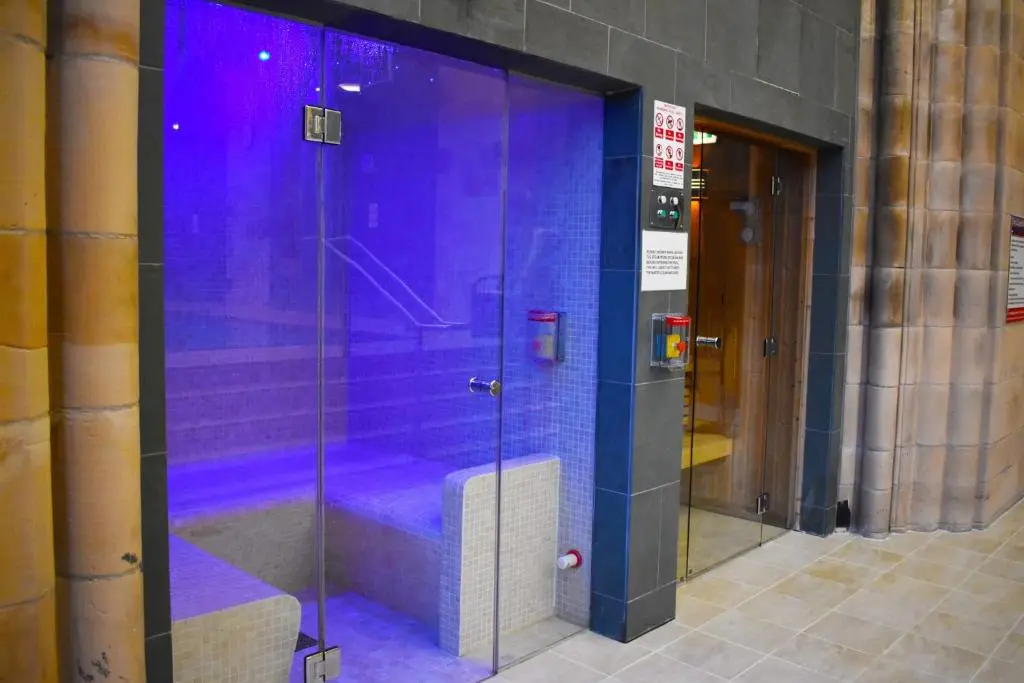 a glass shower in a building with purple lighting at The Ross 2 bedroom apartment in historic Abbey in Fort Augustus