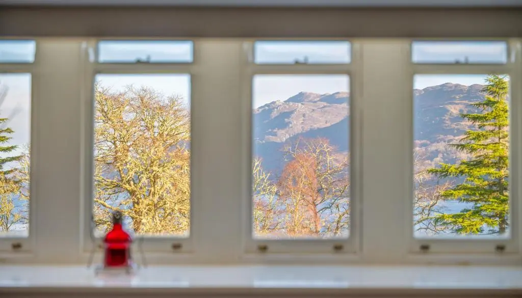 a row of windows with a view of mountains at Monastery apartment with Loch Ness view in Fort Augustus