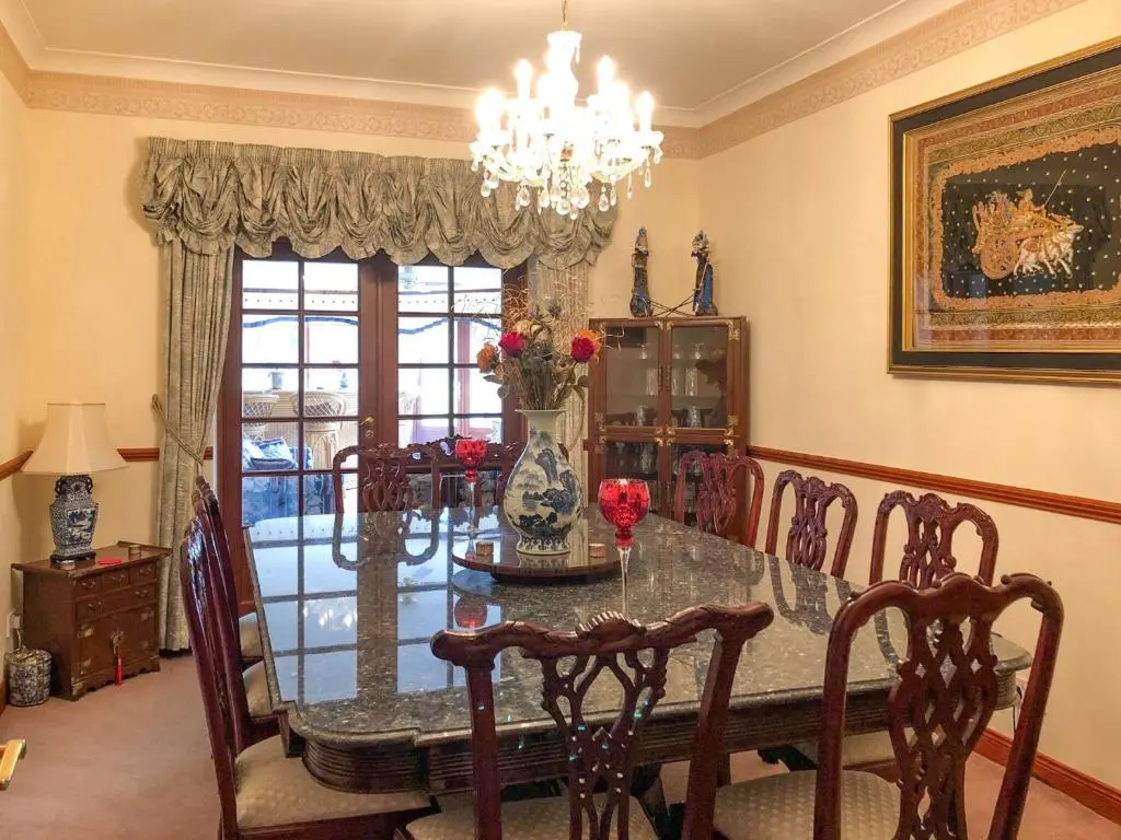 a dining room with a table with chairs and a chandelier at Scardroy Alford in Alford