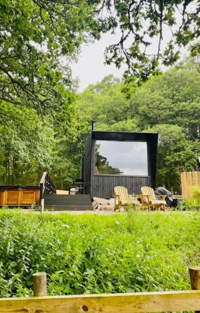 a small cabin in the middle of a garden at The Roost in Aviemore