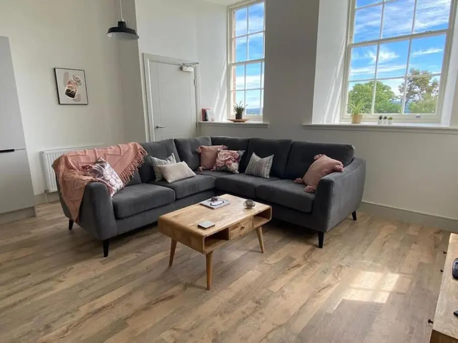 a living room with a couch and a coffee table at Hiltula spacious premium apartment with beautiful views in Inverness