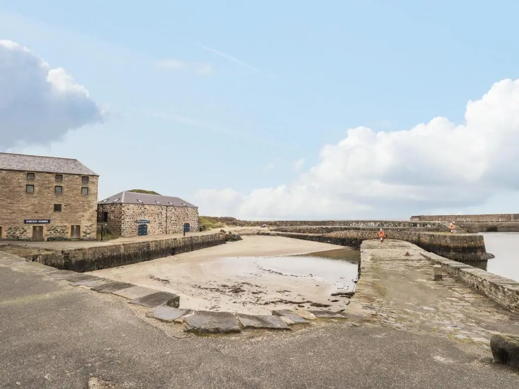 an old stone bridge over a body of water at 20 South High Street in Portsoy