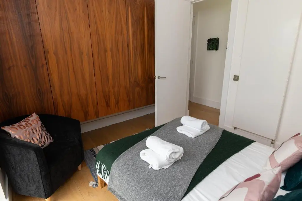 a bedroom with a bed with two towels on it at A Stunning State Of The Art Eco Home - Games Room in Westhill