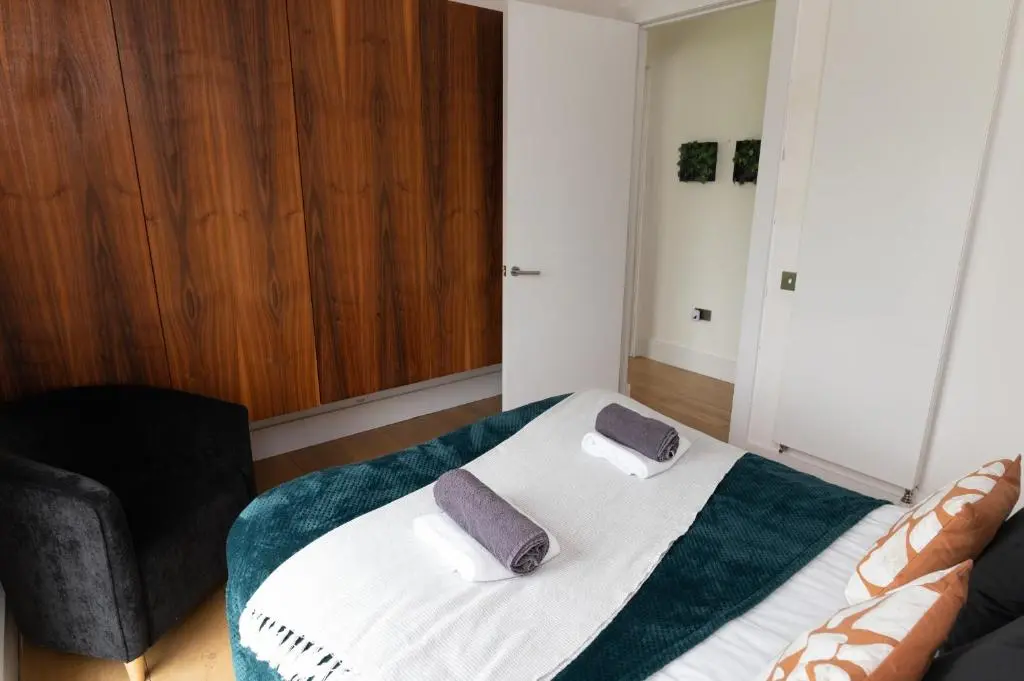 a bedroom with a bed with two pillows on it at A Stunning State Of The Art Eco Home - Games Room in Westhill