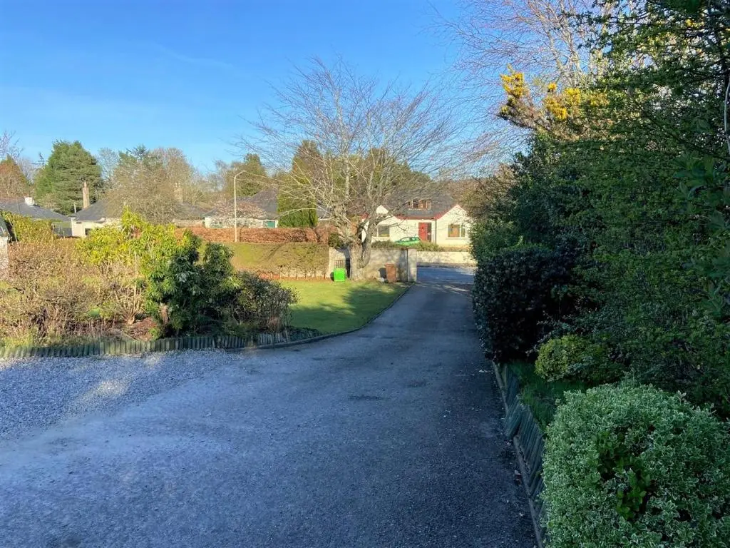 a winding road in a residential neighborhood with houses at Chalet on the Green - Self Contained with parking. in Inshes