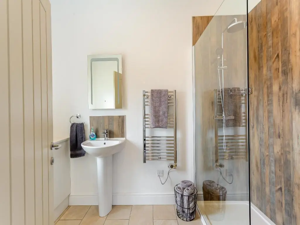 a bathroom with a sink and a shower at Old School House in Altnaharra