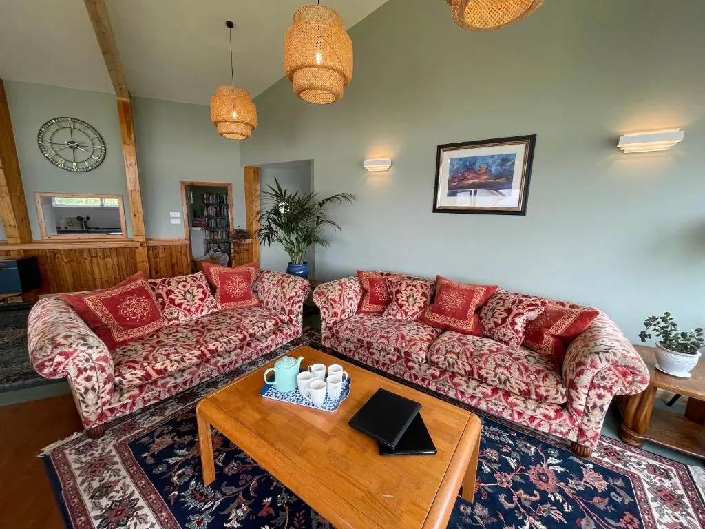 a living room with two couches and a coffee table at Spacious Sea View Home 5 miles from Inverness in North Kessock