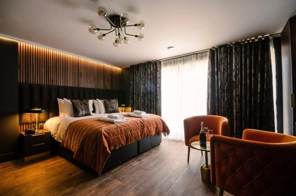 a bedroom with a bed and a window at Sweeney Aviemore One in Aviemore