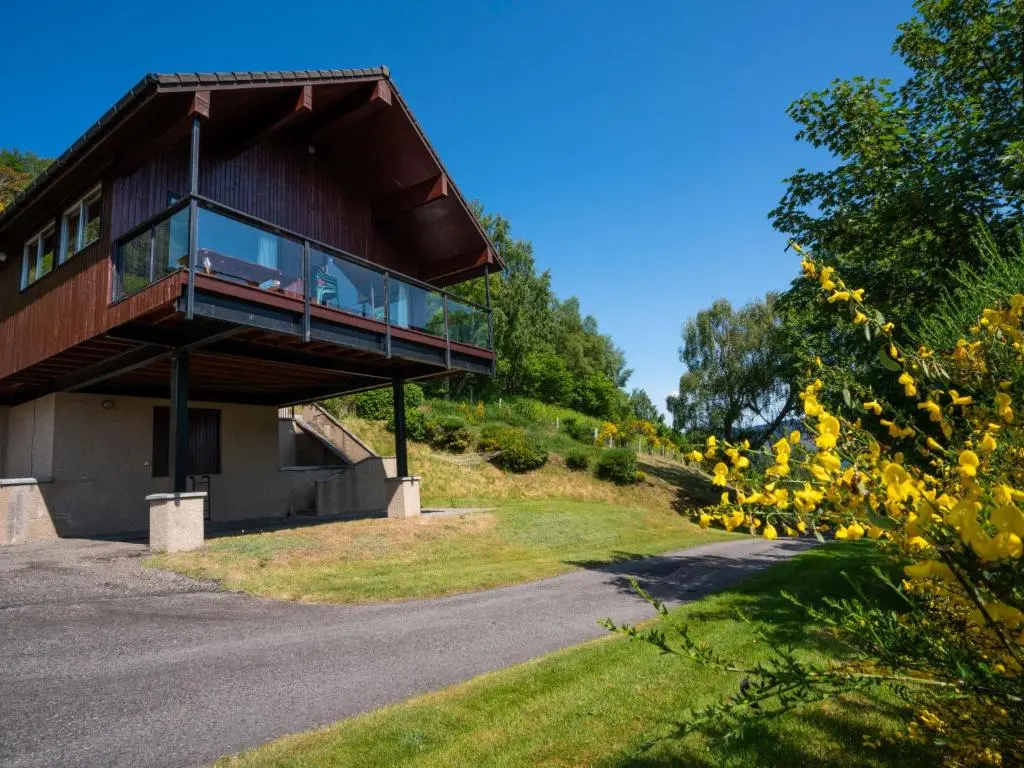 a house on a hill with a balcony at Holiday Home Achmony Number 6 by Interhome in Drumnadrochit