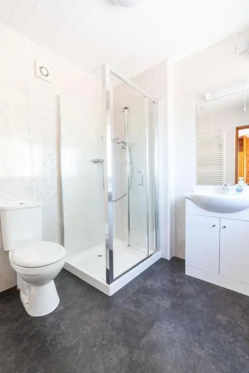 a bathroom with a shower and a toilet and a sink at Holiday Home Achmony Number 6 by Interhome in Drumnadrochit