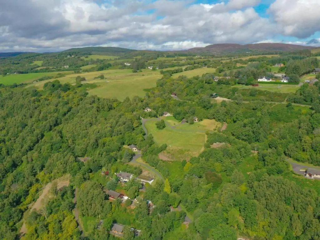 an aerial view of a green valley with houses and trees at Holiday Home Achmony Byre by Interhome in Drumnadrochit