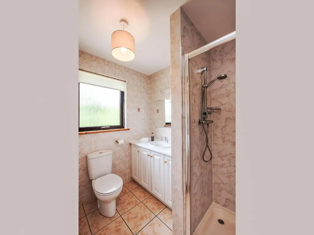 a bathroom with a toilet and a shower and a sink at Holiday Home Achmony Number 11 by Interhome in Drumnadrochit
