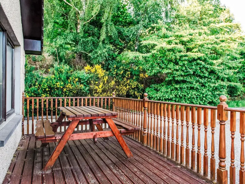 a wooden picnic table sitting on a wooden deck at Holiday Home Achmony Number 11 by Interhome in Drumnadrochit