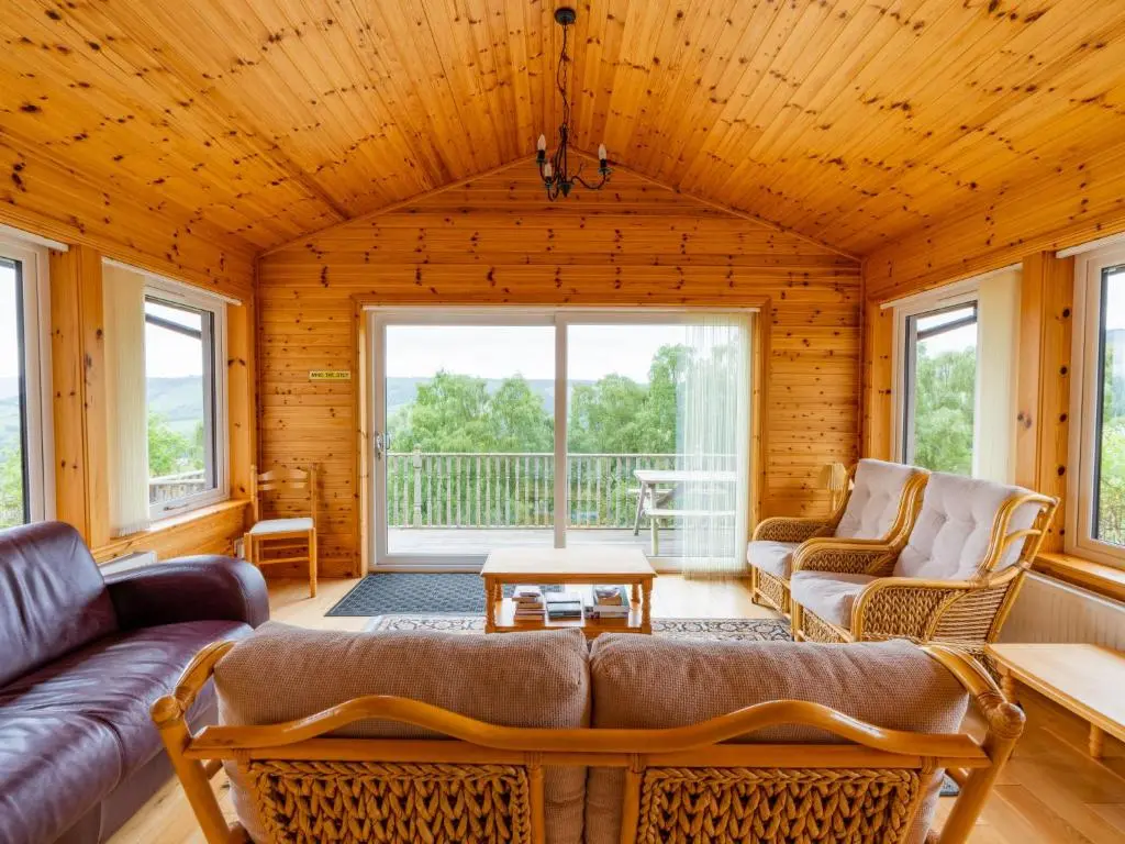 a living room with a couch and a table at Holiday Home Achmony Number 7 by Interhome in Drumnadrochit