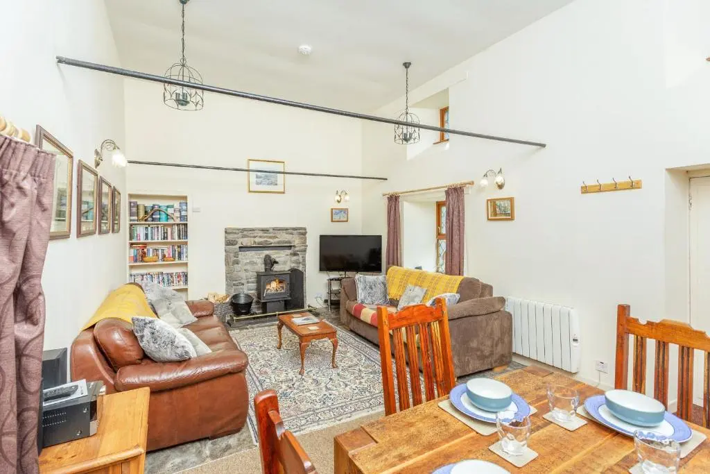 a living room with a couch and a table at The Old Mill in Beauly