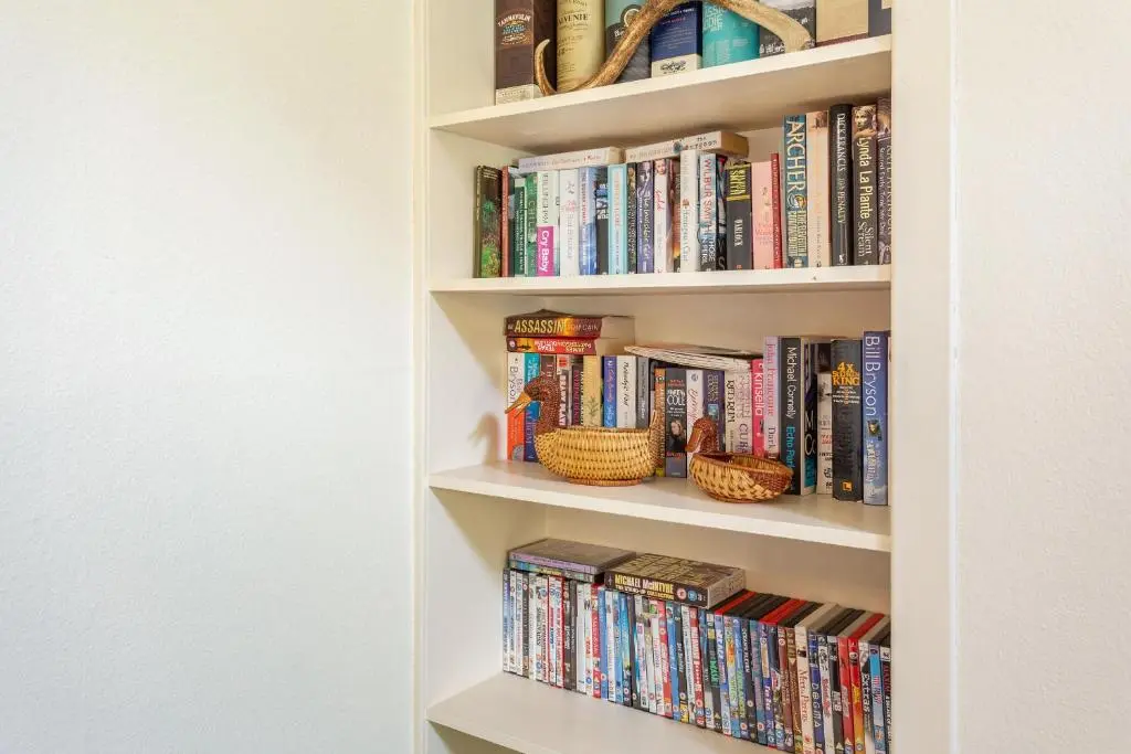 a book shelf filled with lots of books at The Old Mill in Beauly