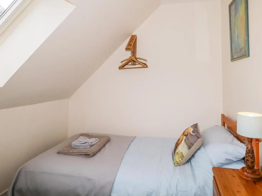a bedroom with a bed in a attic at The Old Mill in Beauly