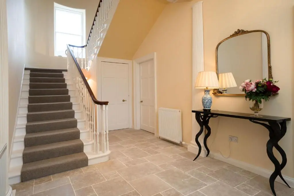 a staircase in a home with a mirror at Kincraig House - Seasgair Lodges in Kincraig