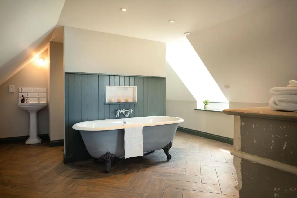 a large bath tub in a bathroom with a window at Kincraig House - Seasgair Lodges in Kincraig