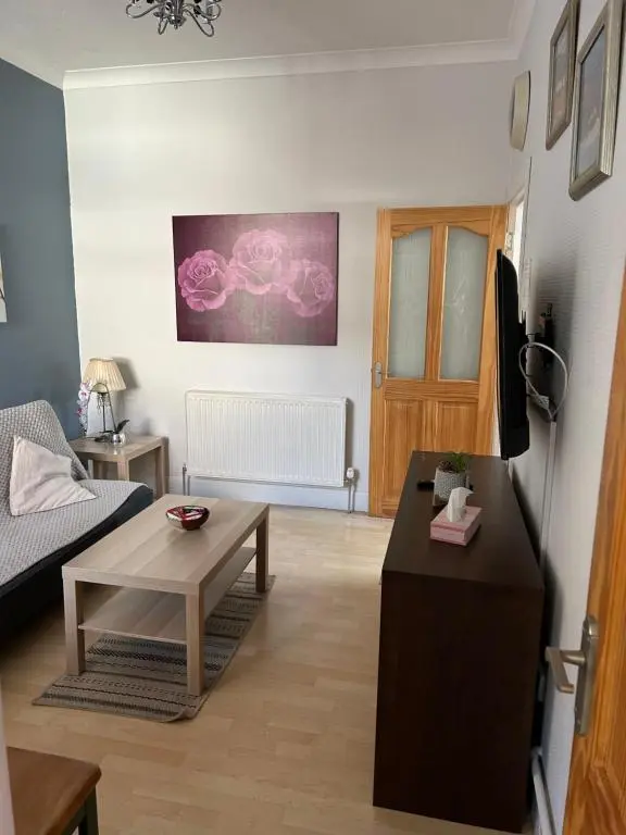 a living room with a couch and a table at Rosebery apartment-Inverness in Inverness