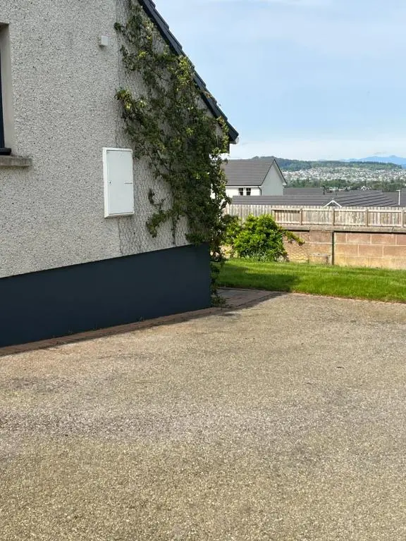 a white door on the side of a building at Bonny Vista in Inverness