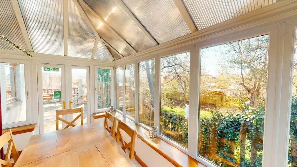 an empty conservatory with windows and a ceiling at The Shieling in Aviemore