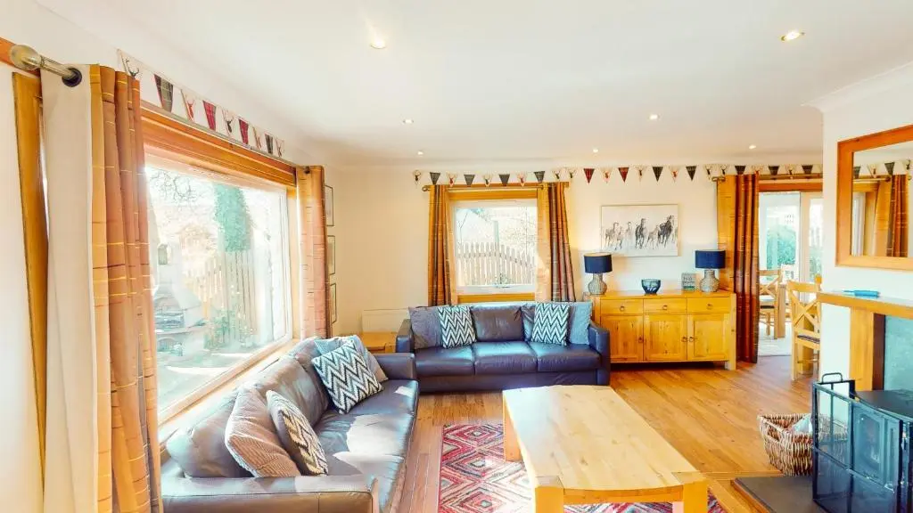 a living room with a couch and a table at The Shieling in Aviemore