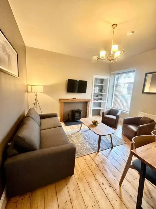 a living room with a couch and a table at Home Sweet Home, Central in Inverness
