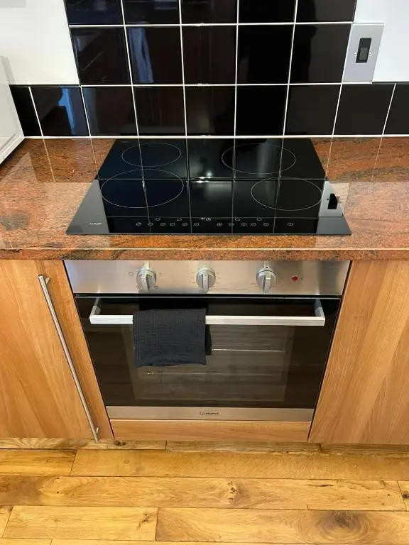 a kitchen with a stove with a counter top at Inverness Highland Apartment in Inverness