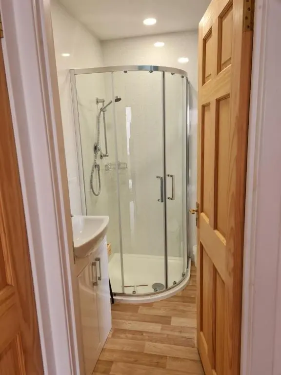 a bathroom with a shower and a sink at 1 Golf Mews in Ballater