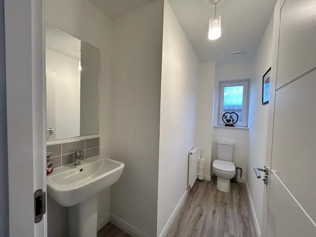 a white bathroom with a sink and a toilet at Faillie in Inverness