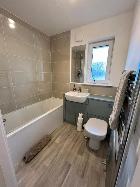 a bathroom with a toilet and a tub and a sink at Faillie in Inverness